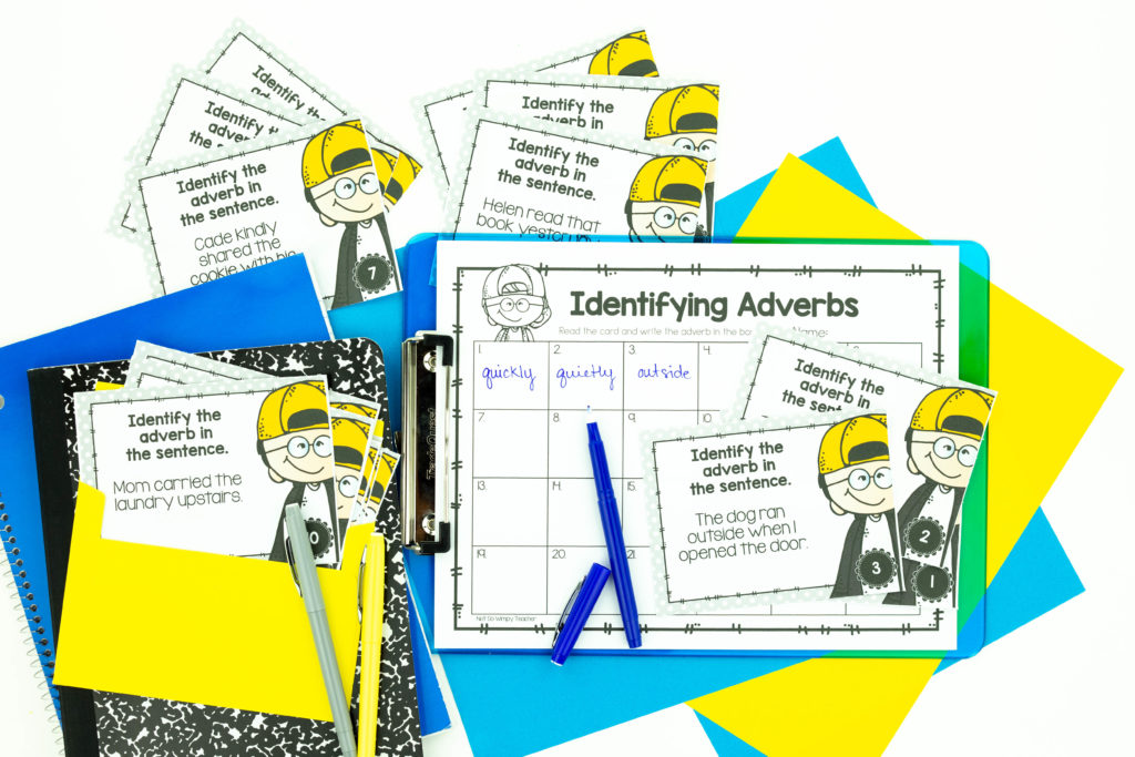 Identifying adverbs grammar activity with task cards and answer sheets on a clipboard