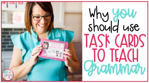 Teacher in teal top holding a task card to teach grammar