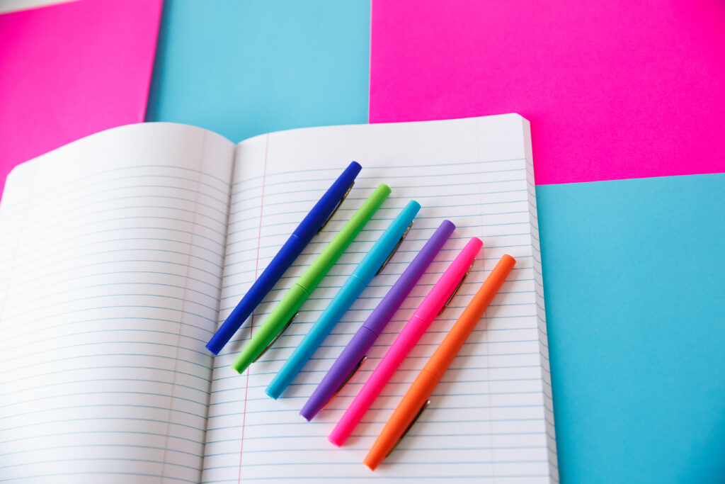 Lined notebook paper with colorful flair pens