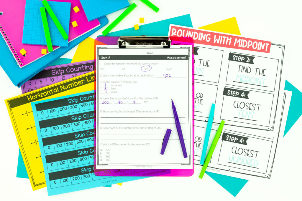 Student activities on purple clipboard with number lines printed on colored paper