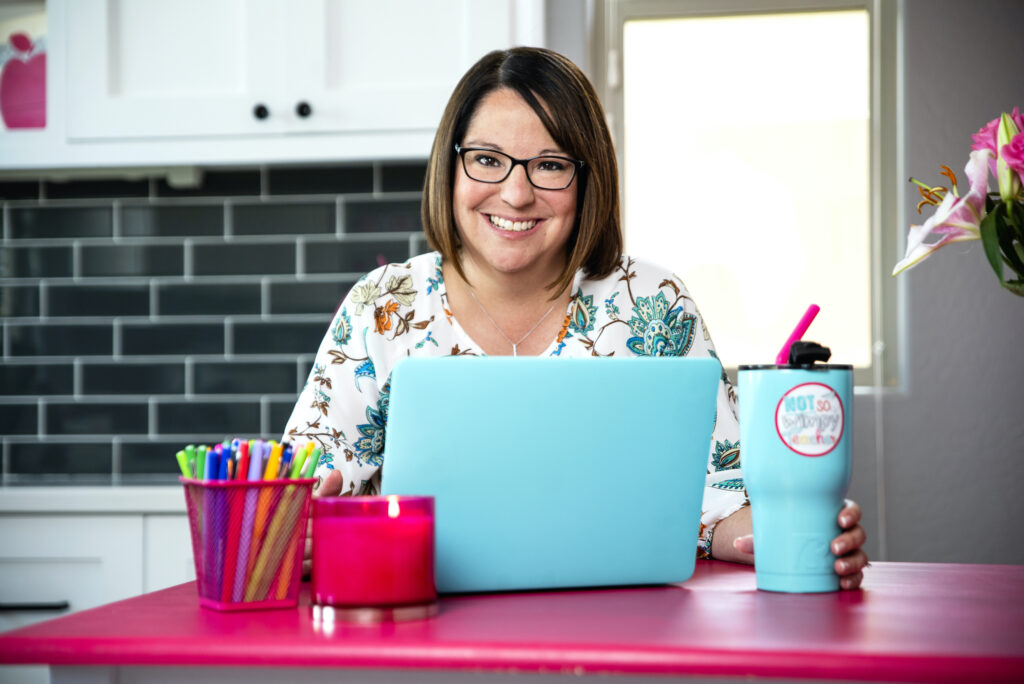 A good teacher working on her teal laptop with NSWT teal mug
