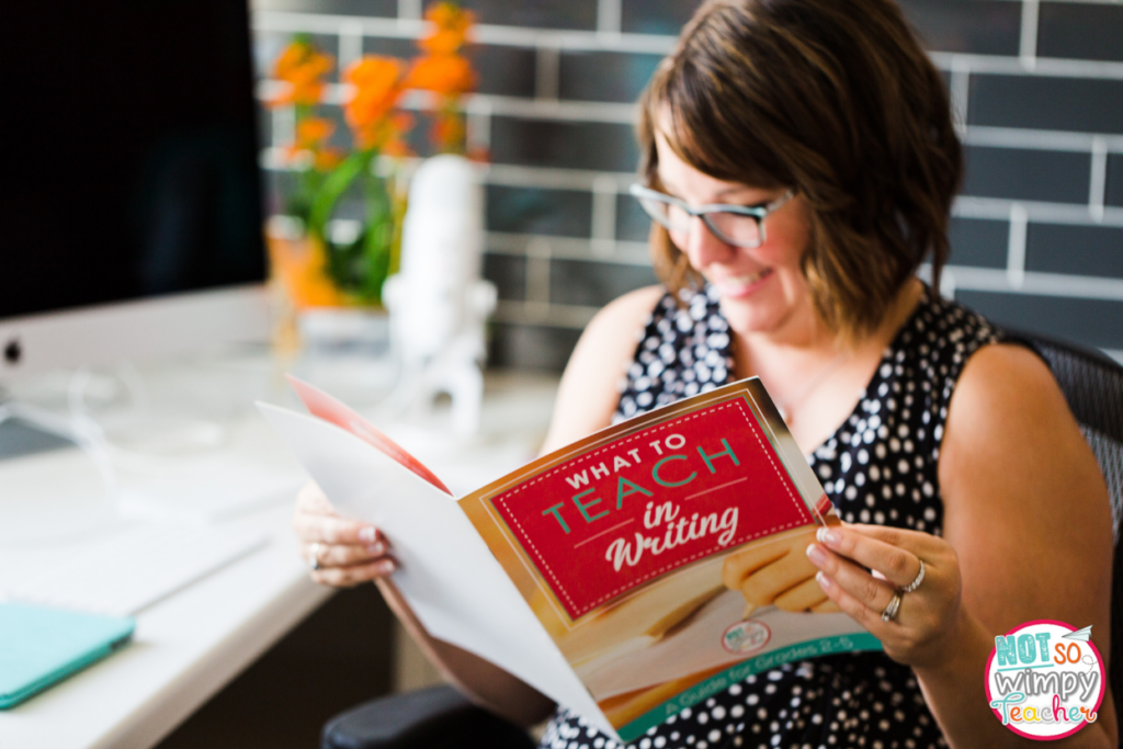 Image of Jamie holding a booklet that says, "What to teach in writing."