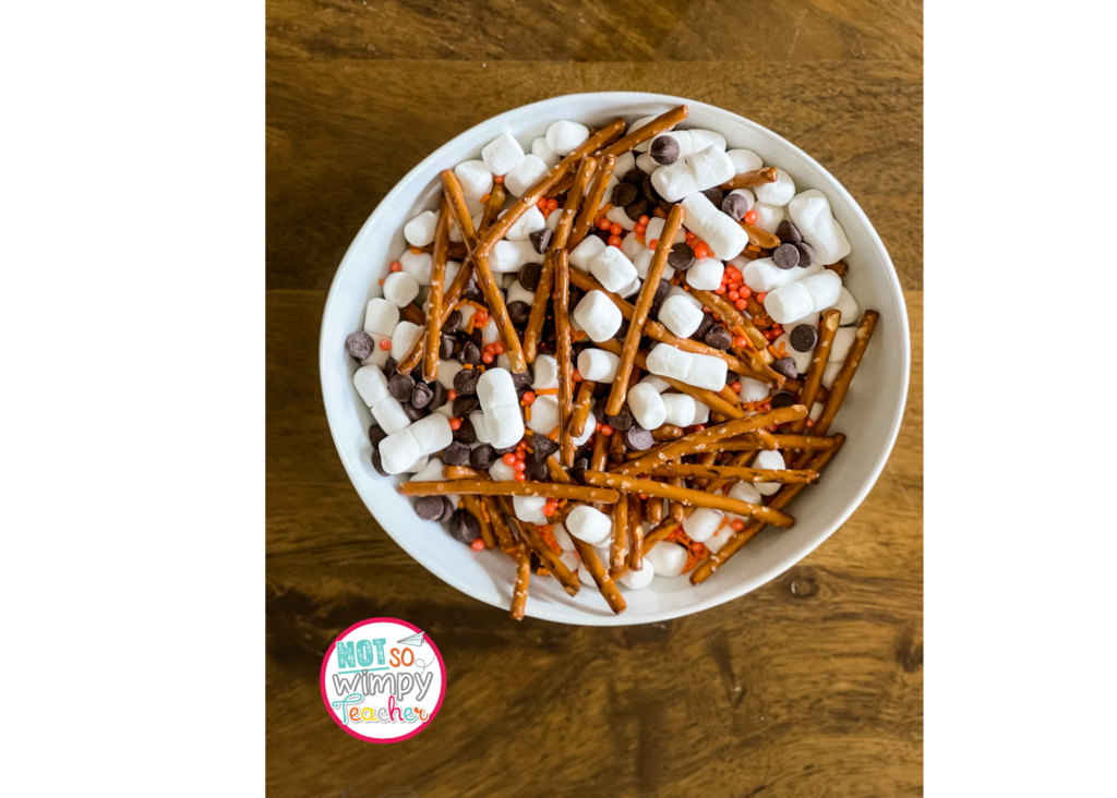 snowman snack mic with pretzels, marshmallows, chocolate chips and orange sprinkles.  